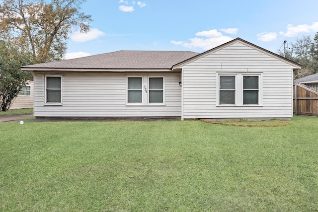 rear view of property with a yard