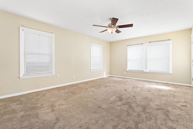 spare room with carpet floors and ceiling fan