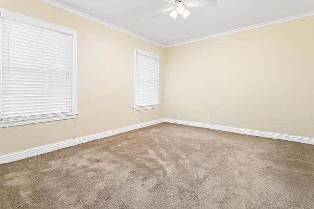 carpeted empty room featuring ornamental molding and ceiling fan