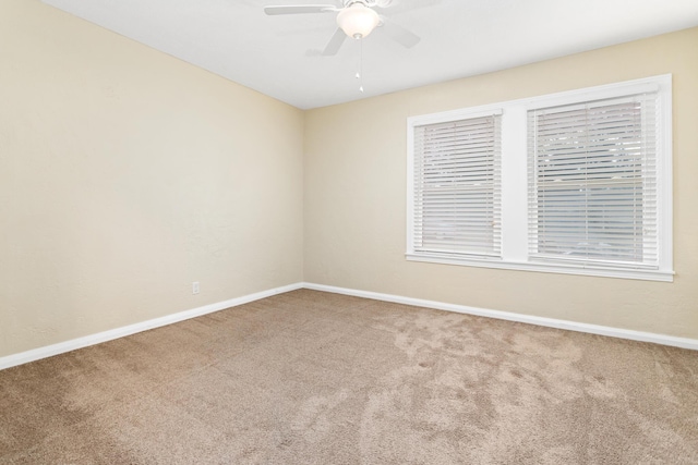 spare room with carpet floors and ceiling fan