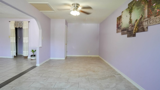 tiled empty room featuring ceiling fan