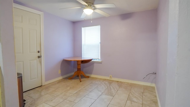 spare room featuring ceiling fan and light tile patterned floors