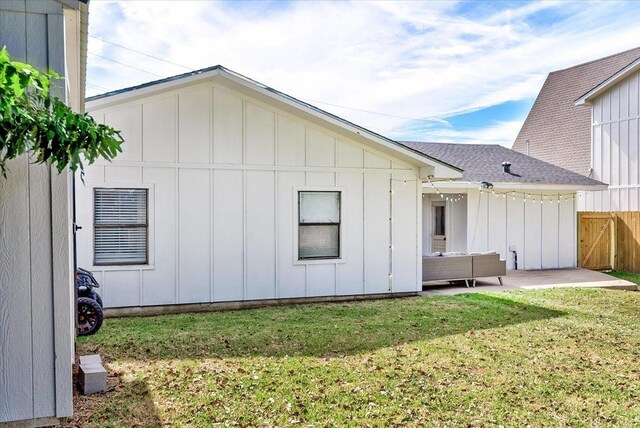 rear view of house with a patio area and a lawn