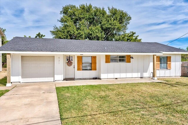 single story home featuring a garage and a front lawn