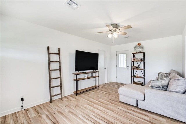 living room with ceiling fan and light hardwood / wood-style floors