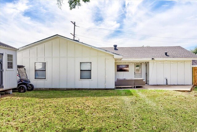 rear view of property featuring an outdoor living space and a yard