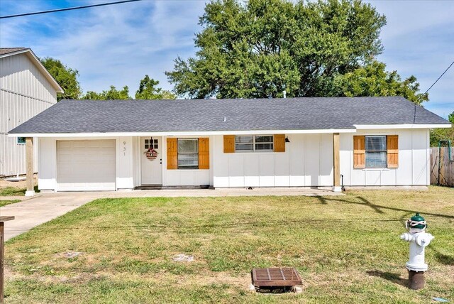 view of front of home with a front yard, a porch, and a garage