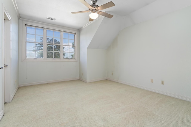 additional living space with ceiling fan, light colored carpet, and vaulted ceiling