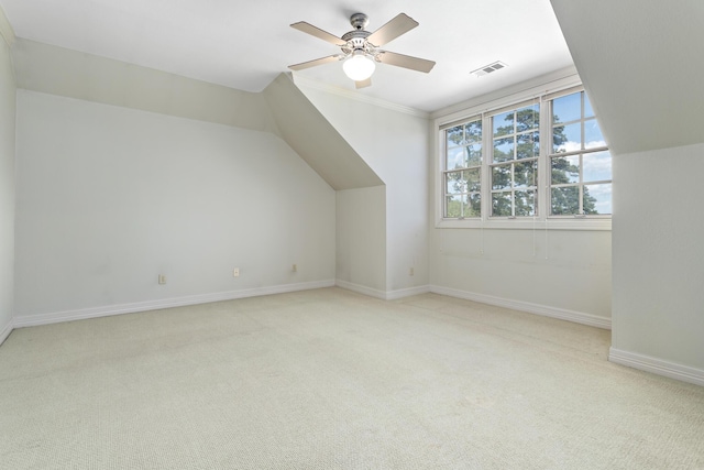 additional living space featuring ceiling fan, light colored carpet, and vaulted ceiling