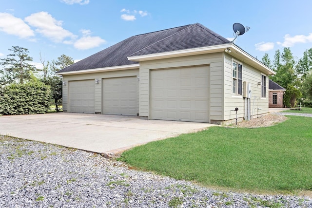 garage featuring a lawn