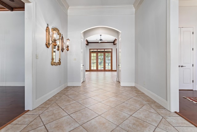 hall featuring french doors, light tile patterned floors, and ornamental molding