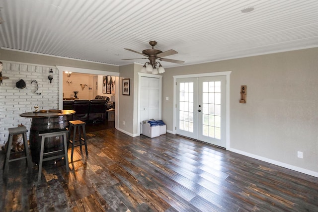 interior space with ceiling fan, french doors, and dark wood-type flooring