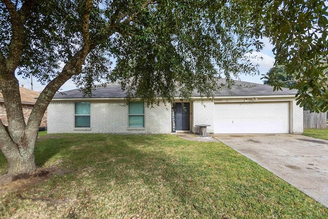 ranch-style house featuring a front yard and a garage