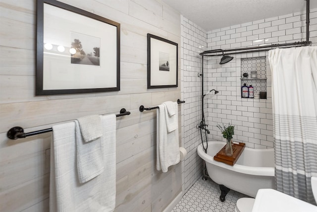 bathroom featuring tile patterned flooring, a textured ceiling, and toilet