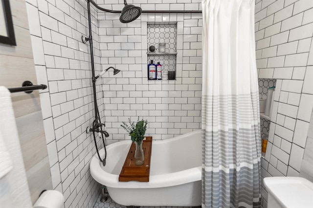 bathroom with toilet, shower / bathtub combination with curtain, and tile walls