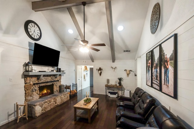 living room featuring wood walls, lofted ceiling with beams, a stone fireplace, hardwood / wood-style flooring, and ceiling fan