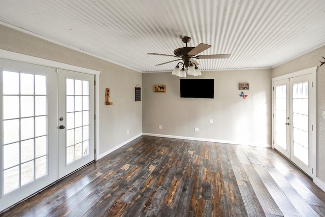 spare room featuring dark hardwood / wood-style flooring, ceiling fan, and french doors