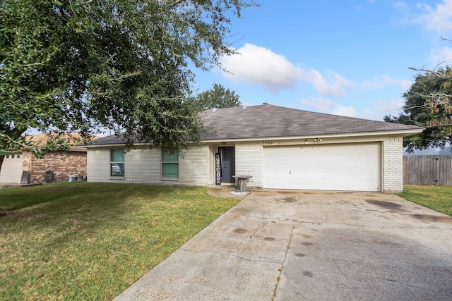 single story home with a front yard and a garage