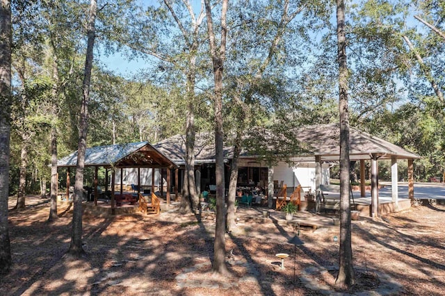 rear view of house featuring a gazebo