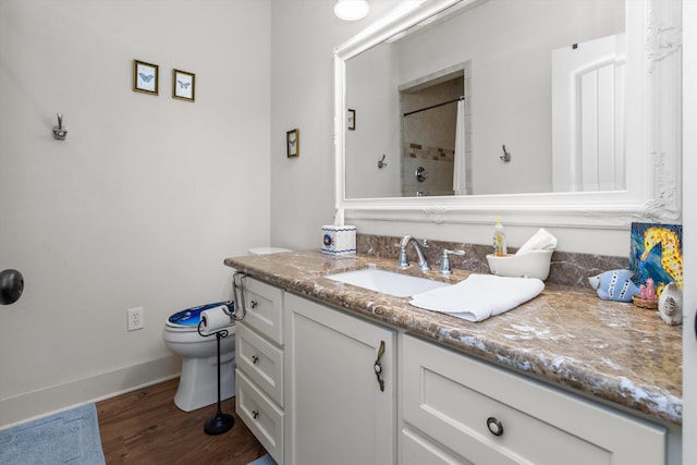 bathroom with toilet, vanity, a shower with shower curtain, and hardwood / wood-style flooring