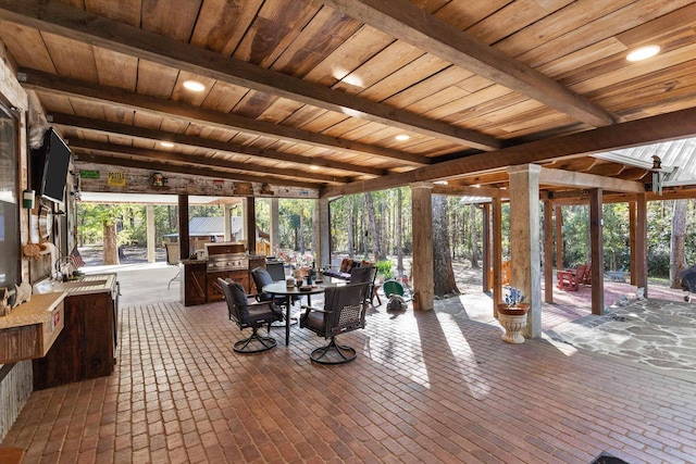 sunroom / solarium featuring beamed ceiling and wood ceiling