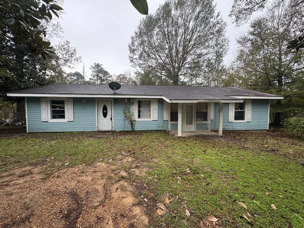 single story home featuring a front lawn