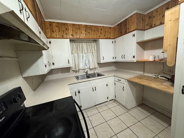 kitchen featuring crown molding, sink, light tile patterned floors, white cabinets, and black electric range oven