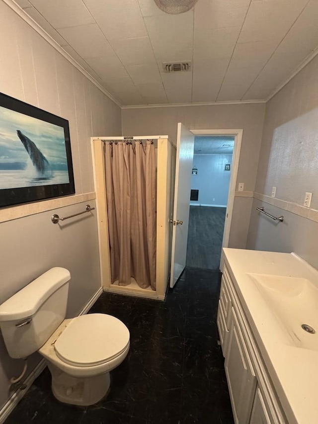 bathroom with vanity, crown molding, and walk in shower