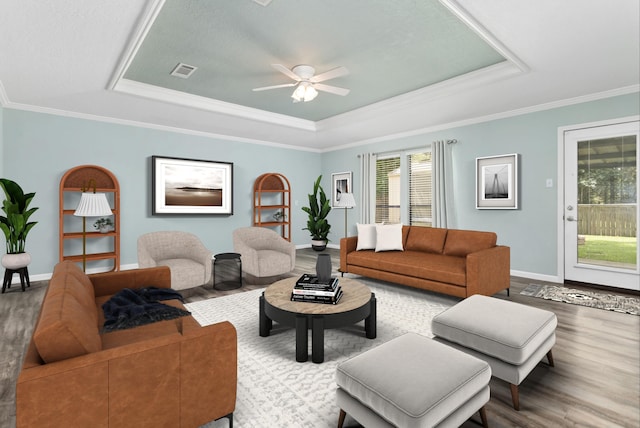 12795 Tanoak Ln, Beaumont, TX 77713 - living area featuring a tray ceiling, wood finished floors, ceiling fan, and crown molding