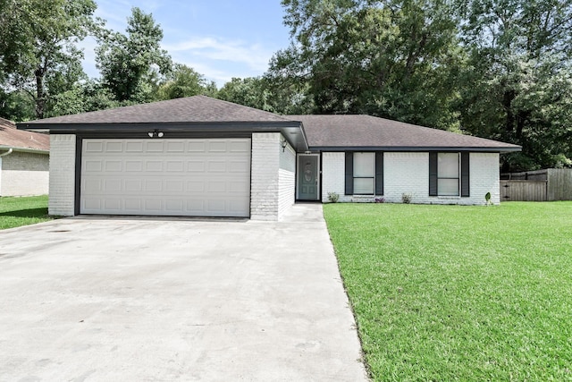 12795 Tanoak Ln, Beaumont, TX 77713 - view of front of property with brick siding, driveway, a shingled roof, and an attached garage