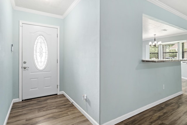 12795 Tanoak Ln, Beaumont, TX 77713 - entrance foyer with a chandelier, crown molding, and wood finished floors