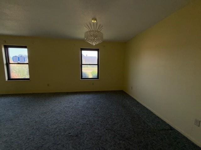 4390 Cartwright St, Beaumont, TX 77707 - unfurnished room with dark carpet and a chandelier