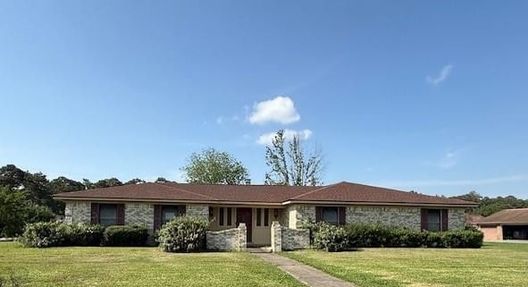 4390 Cartwright St, Beaumont, TX 77707 - ranch-style home featuring a front lawn and stone siding
