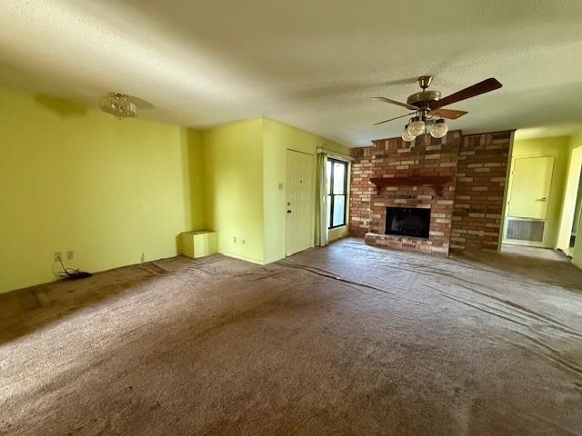 4390 Cartwright St, Beaumont, TX 77707 - unfurnished living room featuring ceiling fan, carpet, a brick fireplace, and a textured ceiling