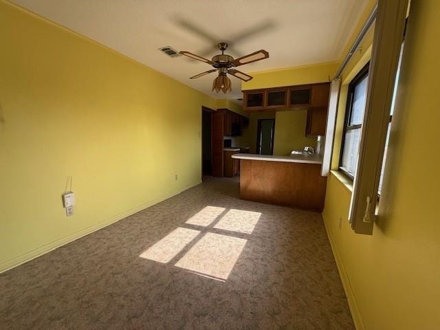 4390 Cartwright St, Beaumont, TX 77707 - unfurnished living room featuring ceiling fan, carpet, and baseboards