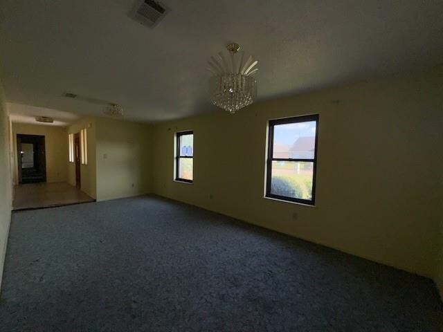 4390 Cartwright St, Beaumont, TX 77707 - empty room with a chandelier and carpet