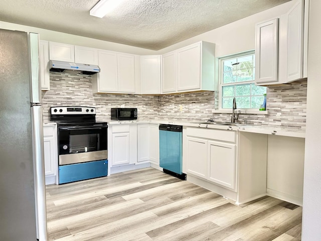 kitchen with white cabinets, appliances with stainless steel finishes, light hardwood / wood-style floors, and sink