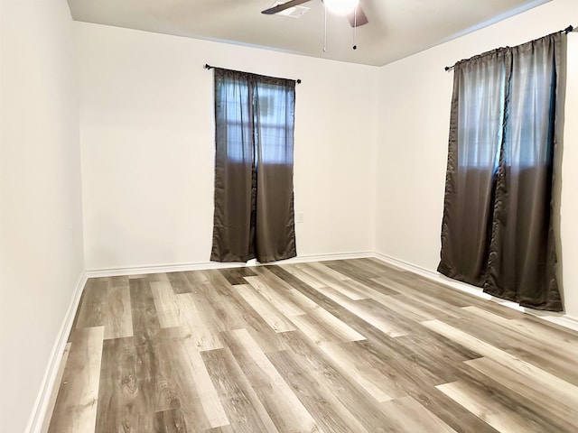 unfurnished room featuring light wood-type flooring and ceiling fan