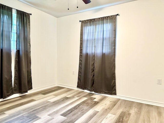 unfurnished room featuring light wood-type flooring and ceiling fan