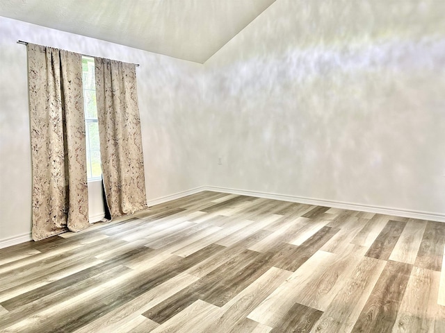 spare room with hardwood / wood-style floors