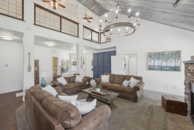 243 Riverbirch, Brookeland, TX 75931 - living room with high vaulted ceiling, baseboards, a ceiling fan, a chandelier, and a stone fireplace