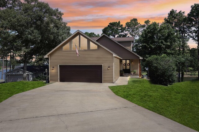 243 Riverbirch, Brookeland, TX 75931 - view of front of house with a front lawn, driveway, and a garage
