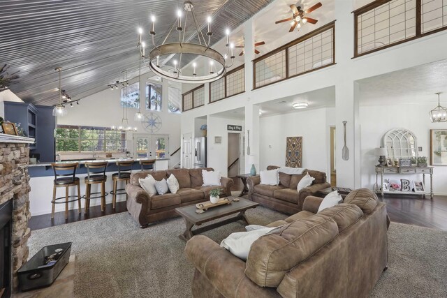 243 Riverbirch, Brookeland, TX 75931 - living room with a chandelier, high vaulted ceiling, wood finished floors, a stone fireplace, and ceiling fan