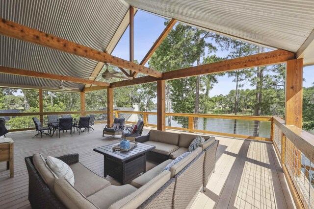 243 Riverbirch, Brookeland, TX 75931 - wooden deck featuring an outdoor living space, outdoor dining area, a water view, view of wooded area, and ceiling fan