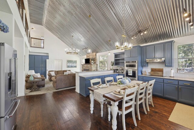 243 Riverbirch, Brookeland, TX 75931 - dining space with a chandelier, high vaulted ceiling, dark wood-style flooring, and wood ceiling