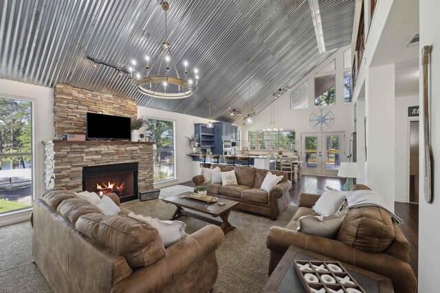243 Riverbirch, Brookeland, TX 75931 - living area featuring a chandelier, high vaulted ceiling, and a fireplace
