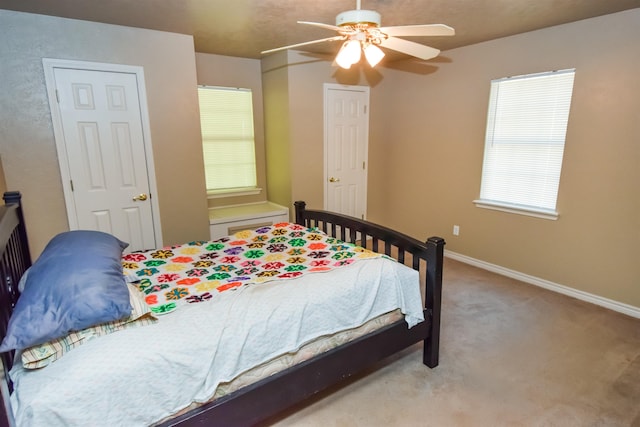 bedroom featuring a ceiling fan, carpet flooring, and baseboards