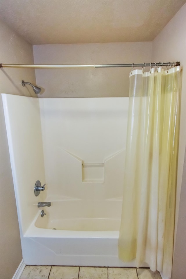 bathroom featuring shower / bath combo with shower curtain and tile patterned floors