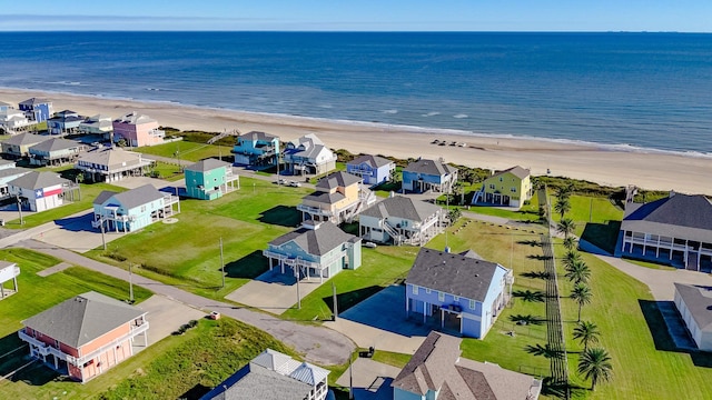 drone / aerial view featuring a water view and a beach view