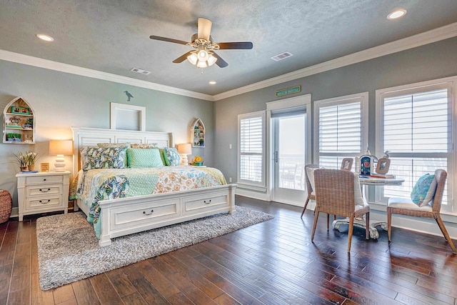 bedroom featuring a textured ceiling, ceiling fan, and crown molding